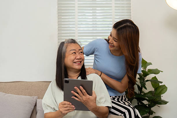 istock Wellness and Modern Living. A mother and daughter share a light-hearted moment while using a tablet together. 2209689685