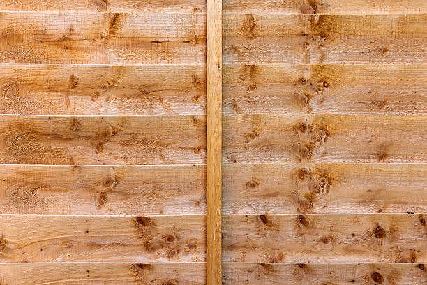 istock Brown Natural Wood Fence Panel With Horizontal Overlapping Boards and Knots 2209691026