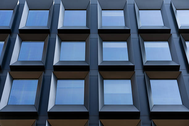 istock Frontal view of sleek contemporary building with deep square windows creating rhythmic architectural surface design 2209691857