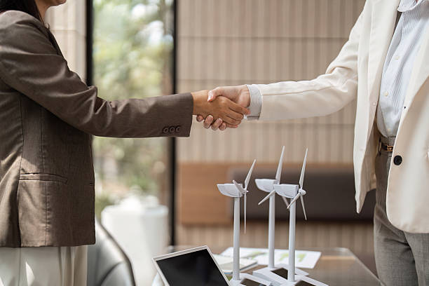 istock Sustainability and Partnership. Two professionals shake hands, celebrating a successful collaboration on sustainable energy solutions. 2209692339