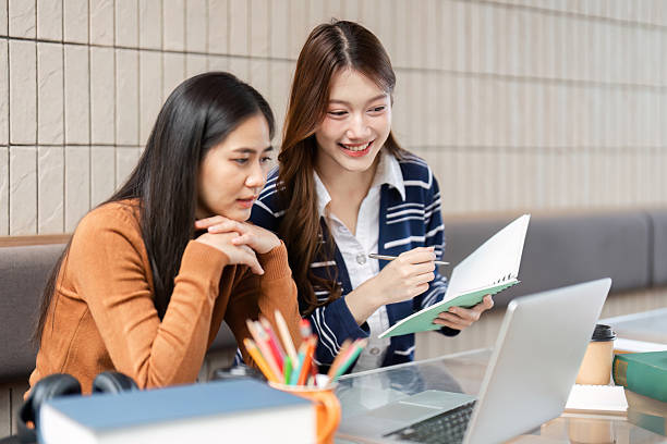 istock Academic Engagement and Support. Two young women discussing study materials while reviewing notes on a laptop. 2209692508