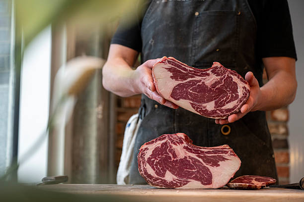 istock Butcher holds raw beef roast 2209692709