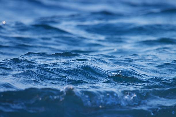 istock Close-up view of ocean waves with sunlight reflecting off the water surface. 2209692754