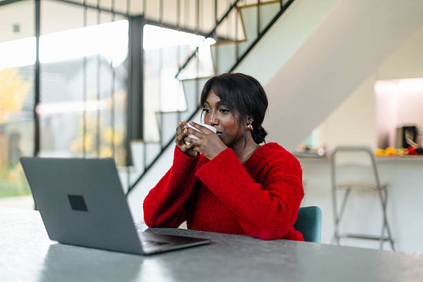 istock Freelancer enjoying hot beverage while telecommuting in modern home office 2209694137