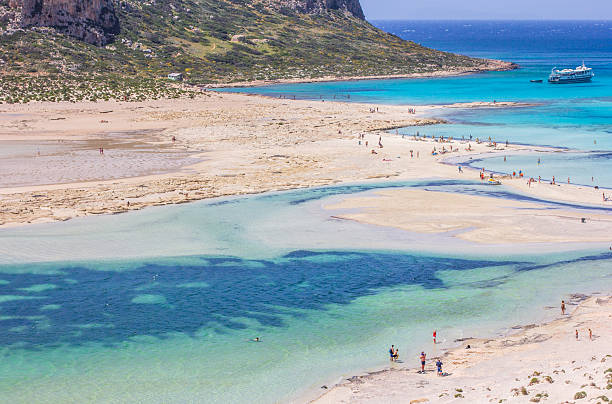 Balos Lagoon is located in the Chania Regional Unit on the northwestern coast of Crete, Greece, at the junction of the Mediterranean Sea and the Aegean Sea. It lies on the Gramvousa Peninsula, approximately 56km northwest of the city of Chania. The lagoon is characterized by shallow waters, white-pink sand due to crushed shells, and protected wetland status within the Natura 2000 network, due to its ecological significance.