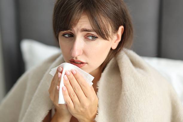 istock Woman wrapped in blanket suffering from sinusitis at home 2209697982