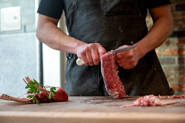 istock Butcher slices raw lamb 2209698228