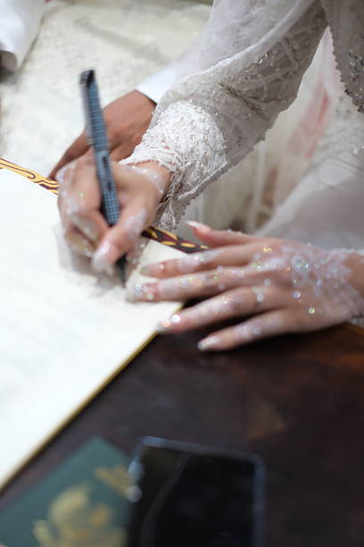 istock signing the marriage certificate 2209698385