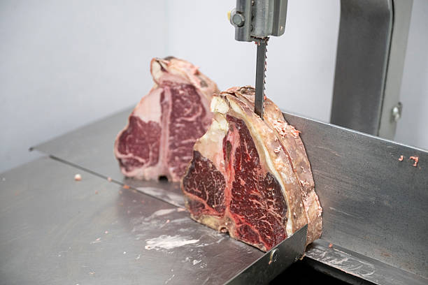 istock Meat slicer and raw T-bone steaks 2209698899