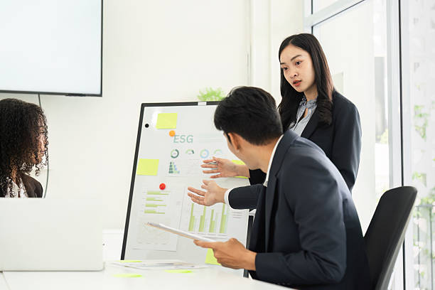 istock Data Analysis and Decision-Making in Sustainability. A team member elaborates on ESG metrics during a presentation. 2209699640