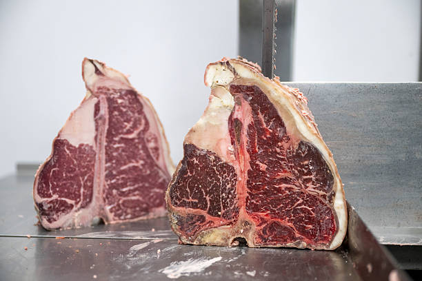 istock Meat slicer and raw T-bone steaks 2209699767