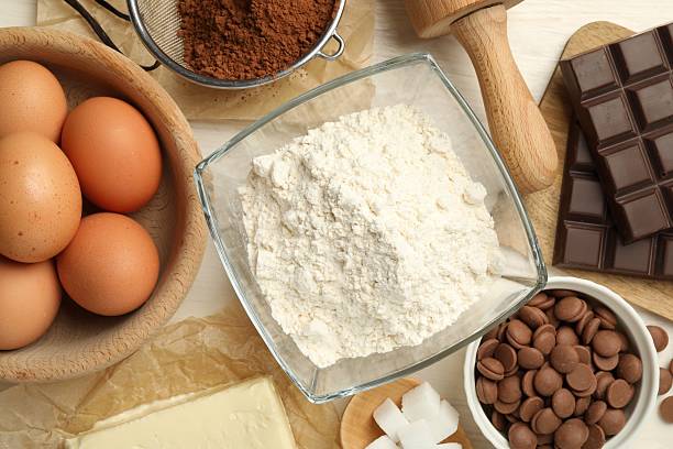 istock Flat lay composition with flour, eggs and other ingredients for making dough on light table 2209699786