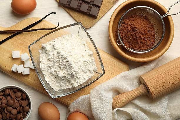 istock Flat lay composition with flour, eggs and other ingredients for making dough on light table 2209699788
