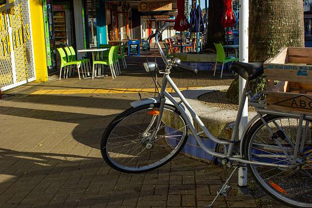 Mount Maunganui, New Zealand – November 04, 2023: A bicycle parked on the main street of Mount Maunganui during a sunny morning
