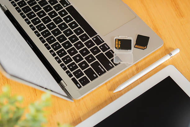 istock Cropped shot of notebook with memory cards, pen, notepad on wooden table. 2209700714