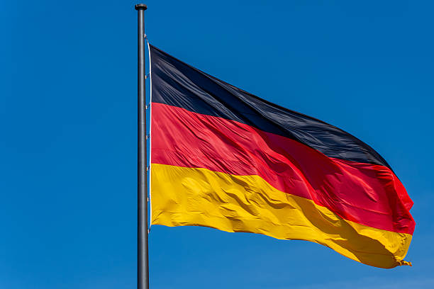 istock A large German flag flutters against a blue sky. 2209703892