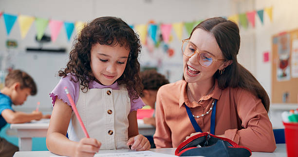 istock Education, girl or teacher with help, learning or fine motor skills with literacy knowledge. Child development, woman or student in classroom, creativity or advice with assessment, writing or support 2209704763