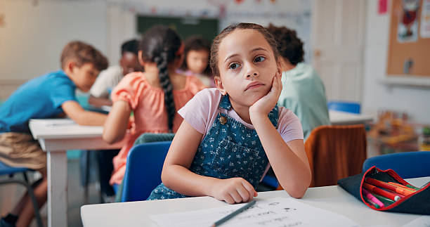 Bored, thinking and student with girl in classroom for education, learning disorder and future. Problem solving, mental health and reflection with child with adhd in school for studying and idea