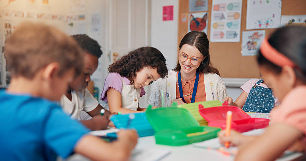 istock Education, study or writing with students and teacher in classroom of school for child development. Knowledge, learning or teaching with happy woman and kids in lesson for academics, course or growth 2209704826