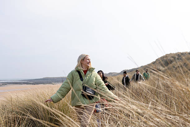 istock Young Adults Enjoying a Beach Hike 2209706181