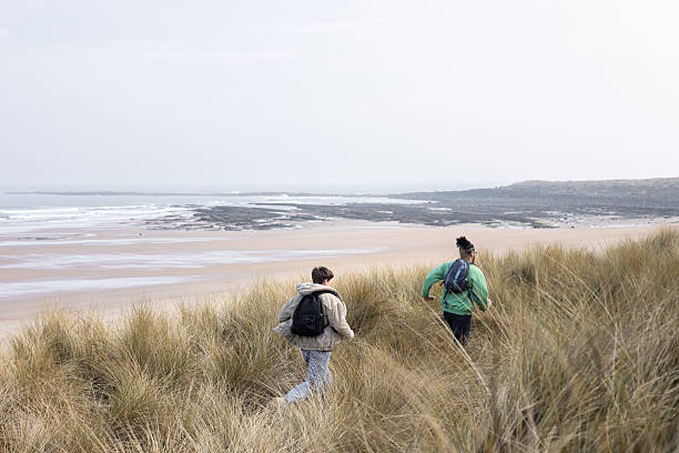 istock Friends Running Through the Dunes 2209706326