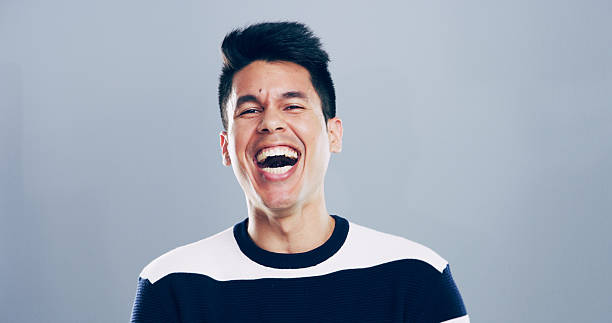 istock Comic, man and portrait for laugh in studio with confidence, joke or good mood on gray background. Space, excited model and smile with carefree personality for comedy, humor or funny reaction to meme 2209713551