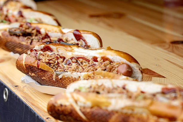 istock Gourmet Hot Dogs On Wooden Board 2209714567