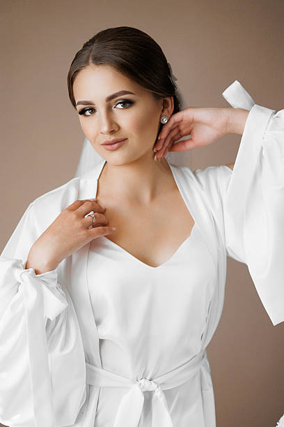 istock A woman in a white robe is posing for a picture 2209715054