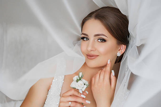 istock A woman is laying on her back with a white veil over her head 2209715155