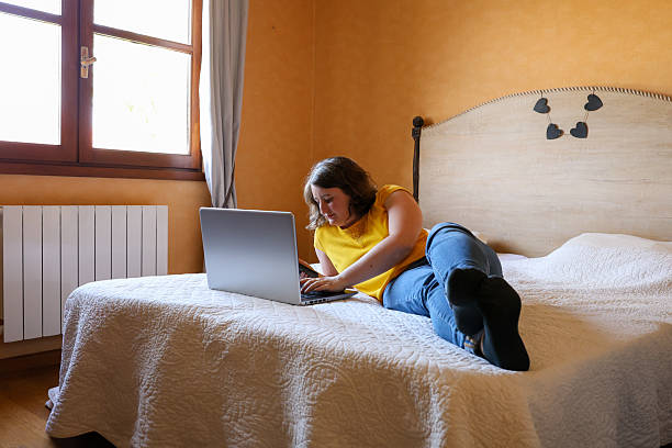istock Woman typing on her computer at the end of the work day 2209716298