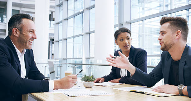 istock Strategy, business people and team in meeting for ideas, brainstorming and problem solving for insight. Collaboration, document and planning for investment, economy or financial discussion in office 2209717974