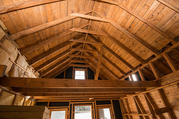 istock Exposed wooden ceiling beams inside unfinished cabin.. 2209719697