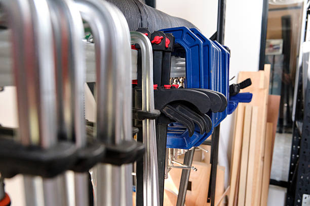istock Closeup of woodworking clamps arranged in a workshop setting 2209721072