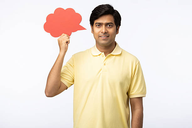 Photo of cheerful excited guy holding talking cloud empty space isolated white background