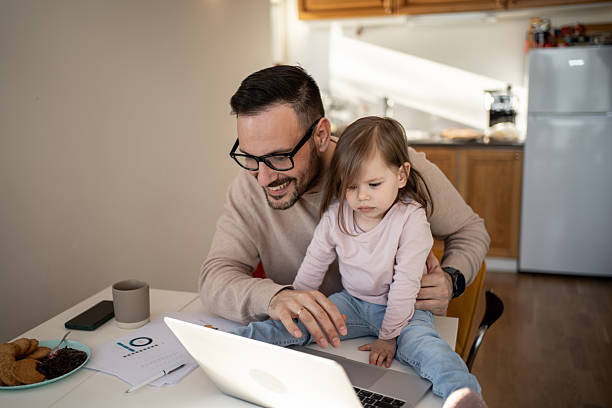 istock Father and daughter working from home on laptop 2209724508