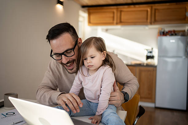 istock Father and daughter sharing a moment of joy while working from home 2209724511