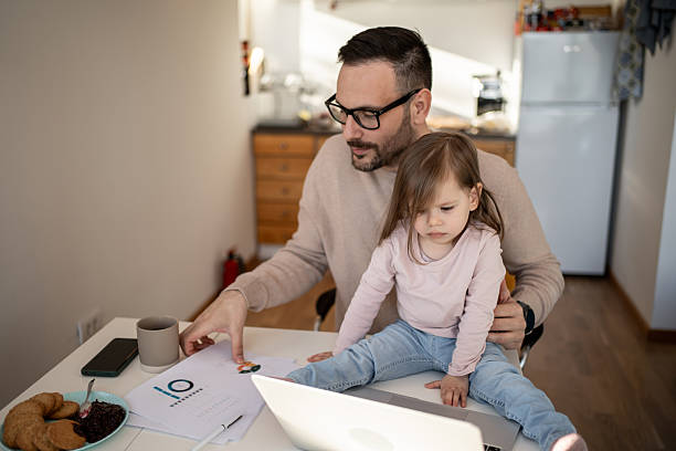 istock Father working from home with daughter on his lap 2209724514