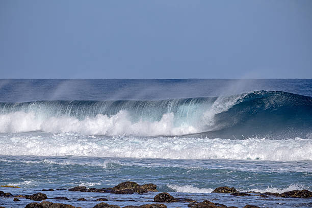 Raw Power of the Atlantic: Towering waves crash against Lanzarote’s volcanic coastline, sending explosive white spray over jagged black lava formations. A dramatic showdown of ocean fury and ancient fire, captured near La Santa. Ideal for adventure travel, nature’s force, or geological power themes.
