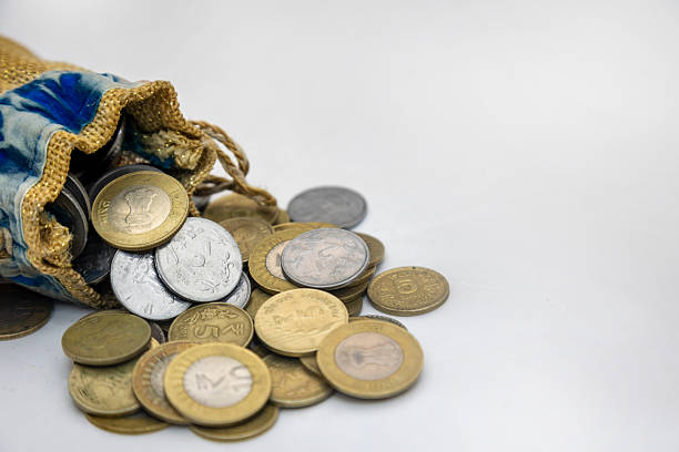 Collection of old 1 BDT Bangladesh Taka brass coins, dated 1996 and 1999, scattered with both sides visible.