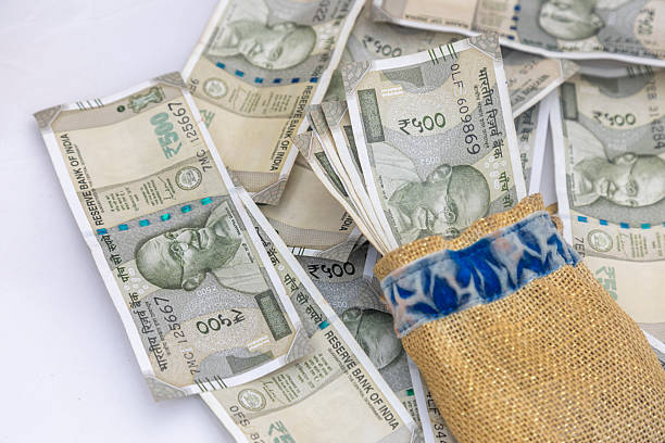 istock Bundle of Indian Rupee Notes in a Pouch on a Pile of Currency 2209726476