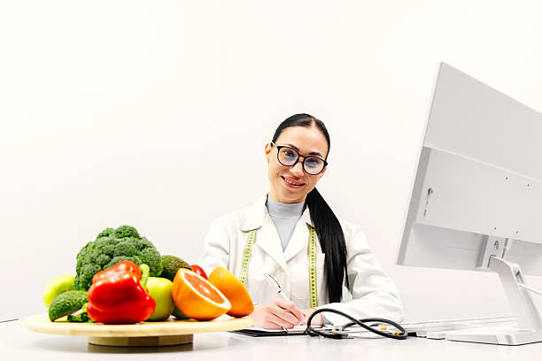 istock Female nutritionist working in a modern clinic on a light background 2209729026