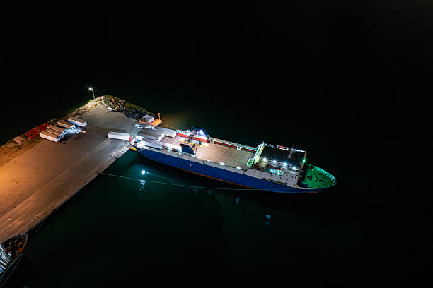 Aerial top view container ship in export and import business and logistics at night