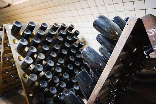 istock Wine bottles resting in wooden racks in a cellar during a fermentation process 2209731231