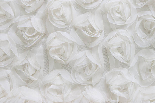 istock Seamless top view of soft white fabric roses forming a romantic floral texture. Ideal background for wedding, Valentines Day, or elegant design projects. Light, pastel, and delicate mood. 2209732009