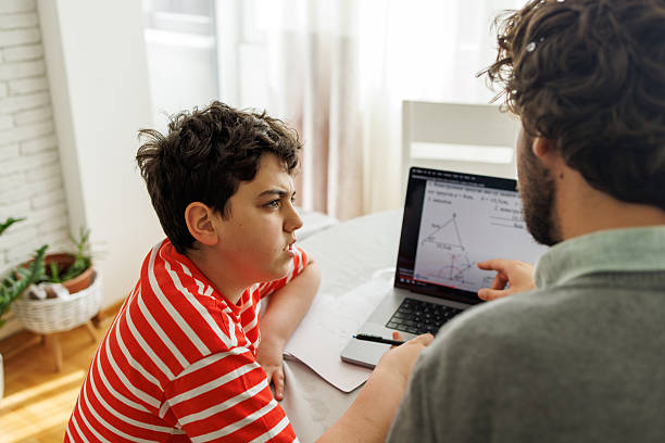 istock Parent Assisting Child with Online Homework 2209736093