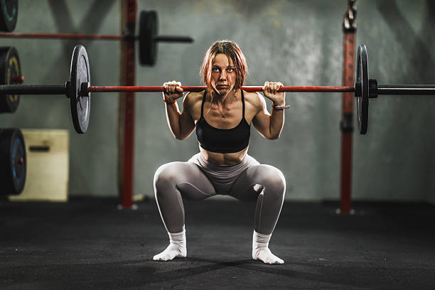 istock Woman Doing Squat Exercise At The Gym 2209736606