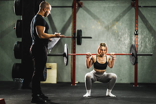 istock Woman Doing Hard Training With Coach At The Gym 2209736645