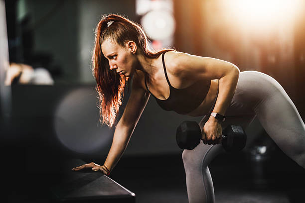 istock Woman Doing Training With Dumbell At The Gym 2209736802