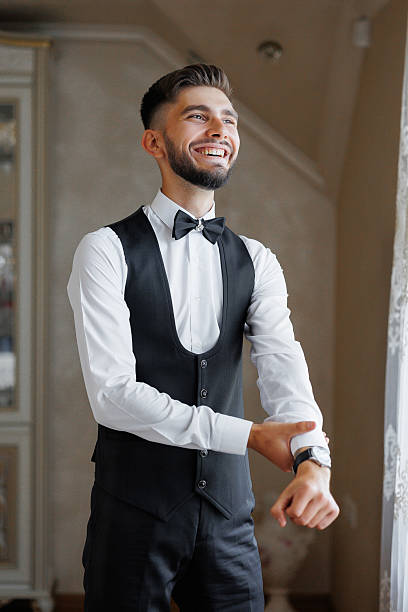 istock A man in a suit and vest is getting ready to go out 2209739785