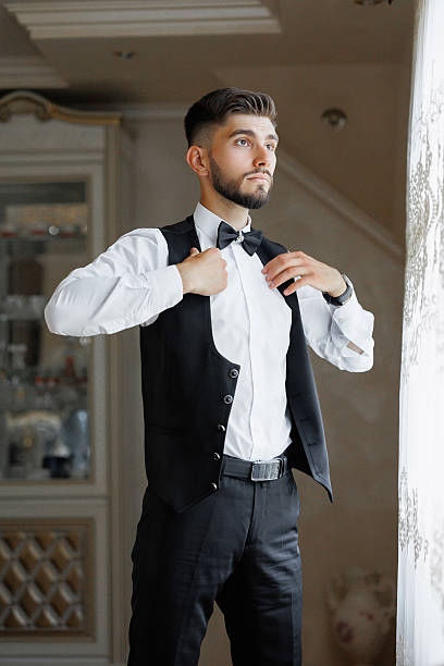 istock A man in a suit and vest is getting ready to go out 2209739794